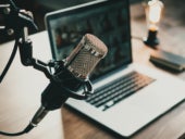 Microphone, laptop and on air lamp on the table, close-up.