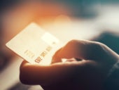 Close-up view of a hand holding a credit card.