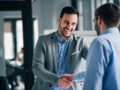 Portrait of two businessmen doing a handshake.